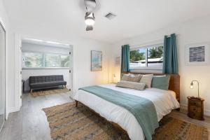 a bedroom with a large bed with blue curtains at Newly renovated 3 bedrooms near the beach and res1 in Pompano Beach