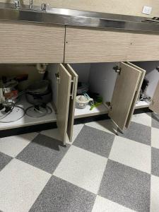 a kitchen with a sink and two open cabinets at Hostel Movistar Arena in Bogotá