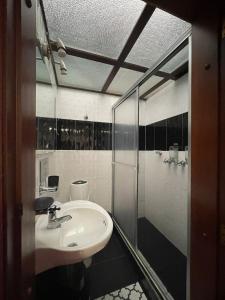 a bathroom with a sink and a shower at Hostel Movistar Arena in Bogotá