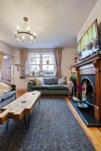 ein Wohnzimmer mit einem Sofa und einem Kamin in der Unterkunft Lilac Cottage Morpeth Northumberland in Morpeth