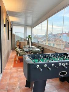 a room with a pool table in front of a window at Tennessee Penthouse in Málaga