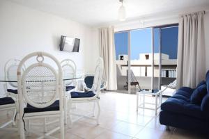 ein Wohnzimmer mit einem Tisch, Stühlen und einem Sofa in der Unterkunft Lindo loft en playa Marlin, 2 min de Plaza la Isla - Mar310 - in Cancún