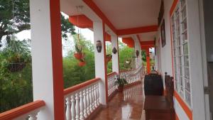a porch of a house with red and white trim at HOTEL REAL VILLA ISABELLA in San Agustín