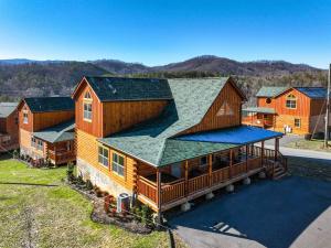 an overhead view of a large wooden house at New Listing! Indoor Private Heated Pool, Less than 2 miles from Dollywood, Walk to Parkway, 4 Ensuite Bedrooms Sleeps 14, Dog Friendly, Game Room with TV, Arcade and Foosball, Hot Tub, BBQ, Smart TV and Wifi, Fully Loaded Kitchen, Washer and Dryer in Pigeon Forge