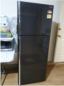 a black refrigerator with a sticker on the door at A cosy private bedroom for you (2) in Warwick Farm