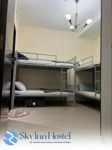 a room with three bunk beds in it at Sky Inn Hostel For Males in Dubai