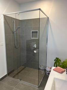 a shower with a glass door in a bathroom at Fusion House in Tranmere +38 photos
