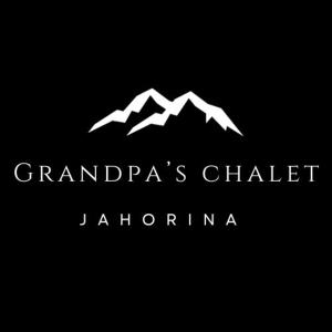 a white mountain logo on a black background at Grandpa's Chalet Jahorina in Jahorina