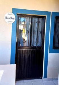 a black door with a sign in front of it at Loft Flor de Pitaya in Cabo San Lucas