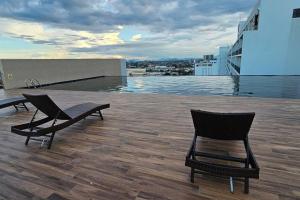 two chairs sitting on the roof of a building at Best Friend Homestay in Kuching