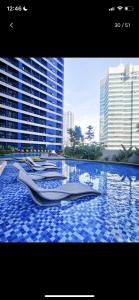 a boat in a pool of water in a city at Air Residences in the Heart of Makati City - Great for Tourists, Staycations or Working Professionals in Manila