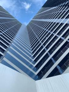 a view of two tall buildings from the ground at Air Residences in the Heart of Makati City - Great for Tourists, Staycations or Working Professionals in Manila