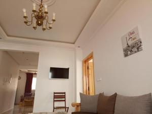 a living room with a couch and a chandelier at Mirleft Seaside Horizon in Mirleft