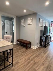 a living room with a couch and a table at Beautifully Acquainted Home. Close to DT GSO! in Greensboro