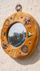 a wooden ornament with a mirror on a wall at Artistic home with fantastic view of la Alhambra in Granada
