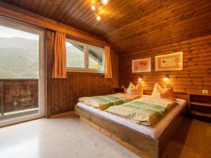 a bedroom with a bed in a wooden room at Resinger in Matrei in Osttirol