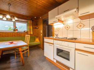 a kitchen and dining room with a table and a stove at Resinger in Matrei in Osttirol