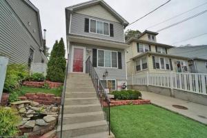 a house with a staircase leading to the front yard at Casa Rosado @ NYC Home Pool Firepit Parking Ferry in Clifton