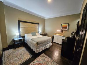 a bedroom with a bed and two tables with lamps at Hotel-Studio @ The Mansfield Midtown in New York