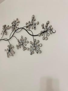 a metal flower wall decoration on a white wall at Melior Grandiose in Liverpool