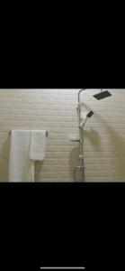 a bathroom with a shower and two towels at Florida Pool & Grill in Nouakchott