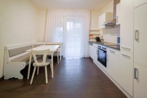 a kitchen with a table and a table and chairs at Smile Apartment - barrierefrei in Tiddische