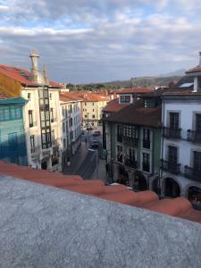 a view of a city with buildings and a street at La plaza in Llanes