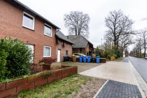 a brick house with a driveway in front of it at Smile Apartment in Tiddische