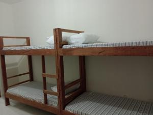 two bunk beds are in a room with a wall at AM-RR Hostel in Manaus