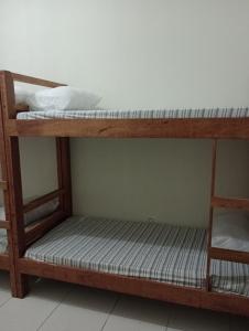 two bunk beds sitting in a room with a wall at AM-RR Hostel in Manaus