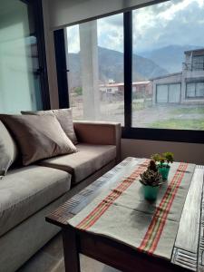 a living room with a couch and a table at Möller Masi in Purmamarca
