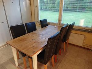 una mesa de madera y sillas en una habitación en Large Apartment, Quality Company Accommodation., en Sundsvall