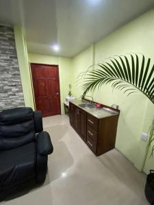 um quarto com uma cadeira, um lavatório e uma porta em Departamento en la Fortuna em La Fortuna