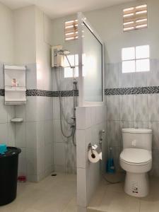 a bathroom with a shower and a toilet in it at Thanid House in Ban Nai Khlong
