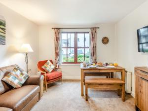 a living room with a couch and a table at Kissing Gate in Keswick