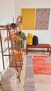 a living room with wooden furniture and a bench at Rumah Penangkap Mimpi in Kertih