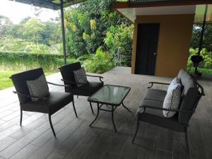 two chairs and a table on a patio at Casa Mangos in Orotina