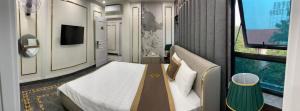 a small room with a bed and a window at Bao Ngoc hotel Pháp Vân in Hanoi