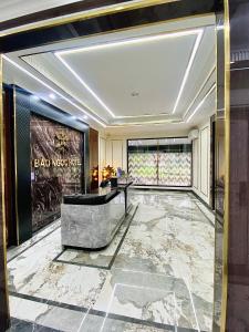 a lobby with a tub and a large window at Bao Ngoc hotel Pháp Vân in Hanoi