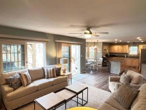 a living room with a couch and a table at LakePath Beach House - XL hot tub, walk to beach in Coloma