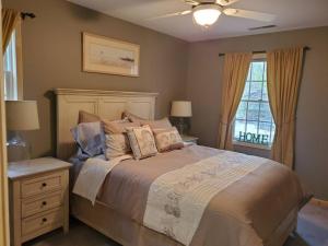 a bedroom with a large bed and a window at LakePath Beach House - XL hot tub, walk to beach in Coloma