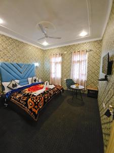 Un dormitorio con una cama temática de tigres y una mesa en Hotel Nouvella Residency, en Srinagar