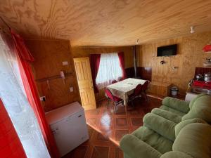 a living room with a couch and a table at Cabañas Amanecer Sector Campo 2 in Castro