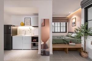 two images of a kitchen and a bedroom at M Village Hoàng Văn Thụ in Ho Chi Minh City