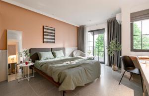 a bedroom with a large bed and a desk at M Village Hoàng Văn Thụ in Ho Chi Minh City