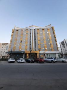 a large building with cars parked in front of it at شقق جوداء الفندقية in Riyadh