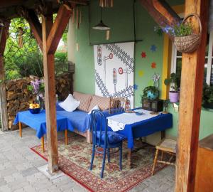 a patio with a table and a couch and a table and chairs at Gościniec pod Kłosem in Kłos