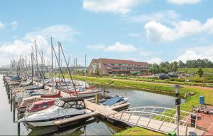 a bunch of boats docked in a marina with a building at Beautiful Home In Bruinisse With Kitchen in Bruinisse