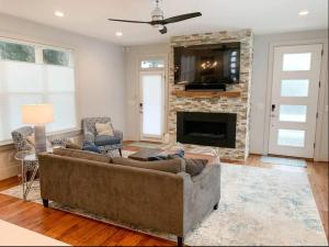 a living room with a couch and a fireplace at City View- near Downtown, Capital, NC State in Raleigh