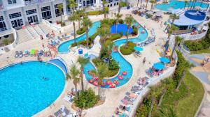 una vista aérea de una piscina en un complejo en Luxury 9th Floor 1 BR Condo Direct Oceanfront Wyndham Ocean Walk Resort Daytona Beach | 908, en Daytona Beach